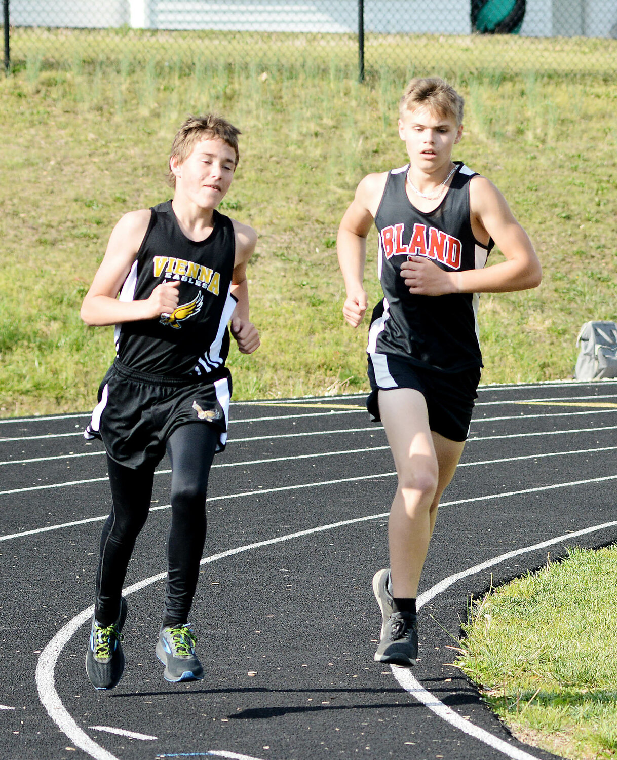 Dalton Timm and Karsin Siefert (from left) represent Maries County in the boys 1600m run during Vienna’s Black and Gold Invitational track meet Monday.
